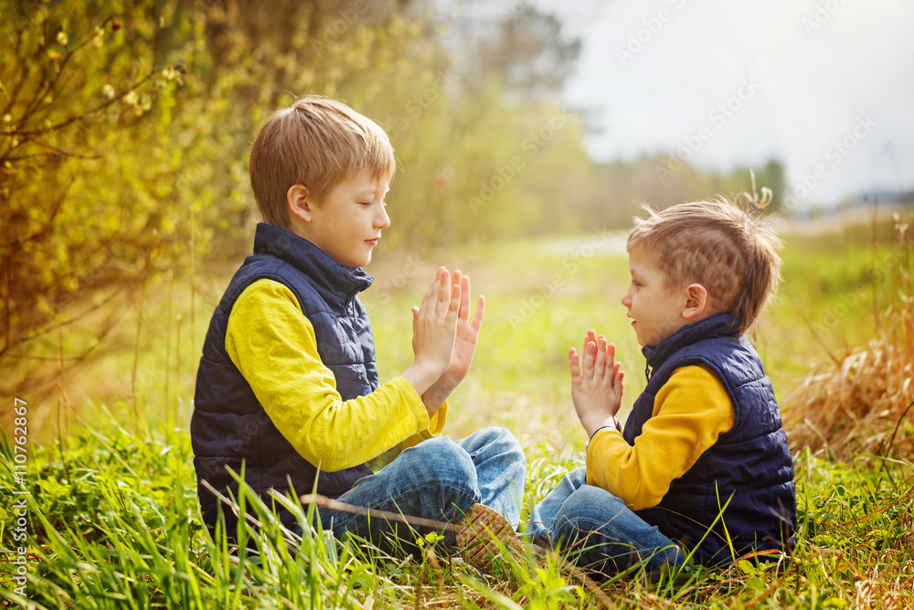 Happy two litte brothers having fun together at the sunny day t Happy two litte brothers having fun together at the sunny day t