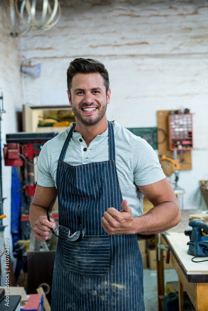 Carpenter smiling and throwing thumb Carpenter smiling and throwing thumb