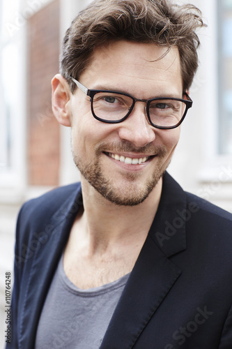 Handsome guy smiling in spectacles, portrait