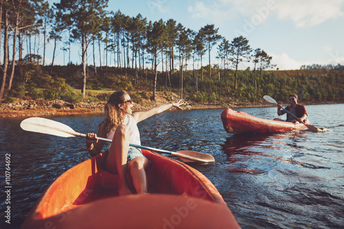 Young couple kayaking on the lake © Jacob Lund