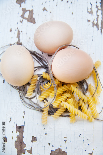 eggs and noodles lying on an old table