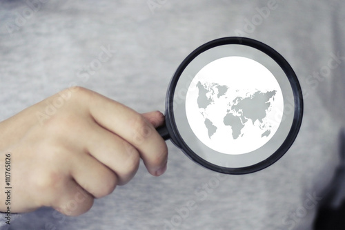 Businessman holds search loupe icon magnifier map button