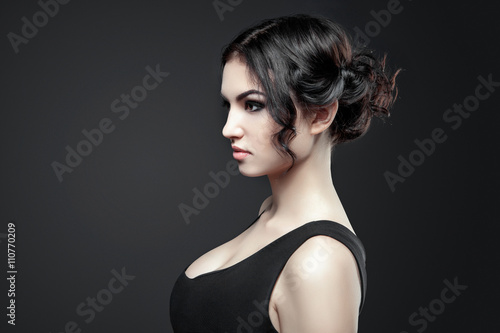 Portrait of beautiful female model on gray background