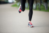 Close-up view of runner woman legs on the street