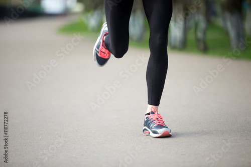 Close-up view of runner woman legs on the street