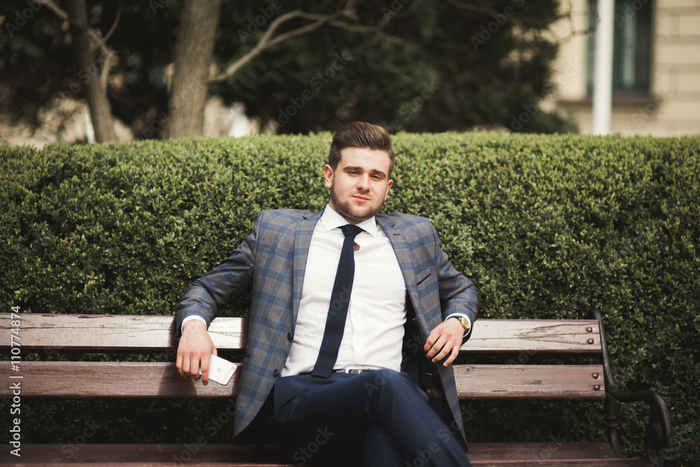 Obraz premium Handsome stylish young businessman posing portrait outdoor