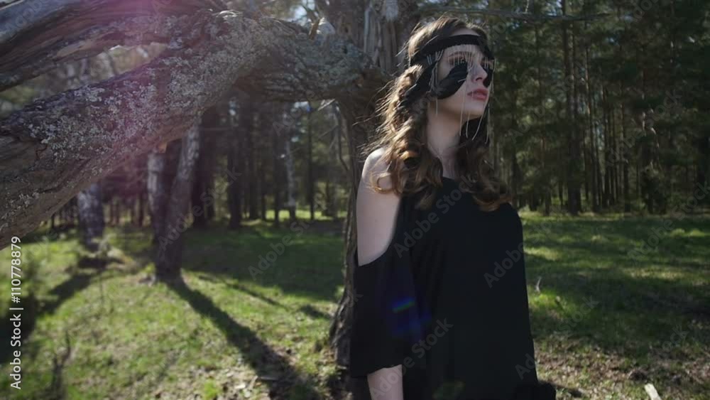 Beautiful girl in a black dress walks in the woods Beautiful girl in a black dress walks in the woods