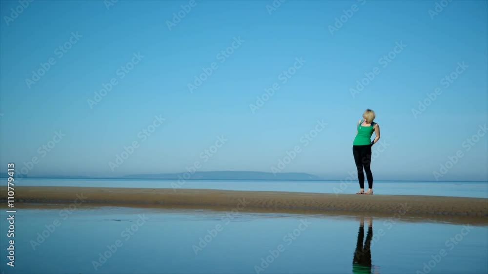 young pretty woman doing yoga on the beach in the afternoon young pretty woman doing yoga on the beach in the afternoon