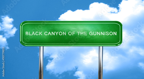 Black canyon of the gunnison vintage green road sign with highli