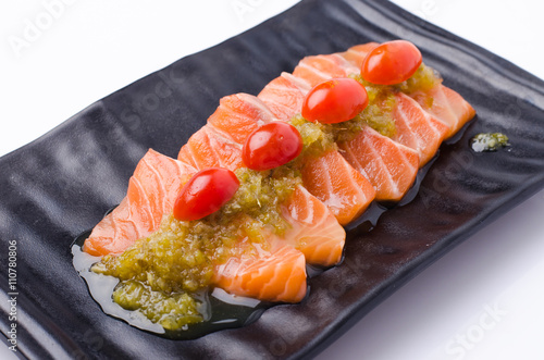 Slices of Salmon Served with Spicy Sauce photo