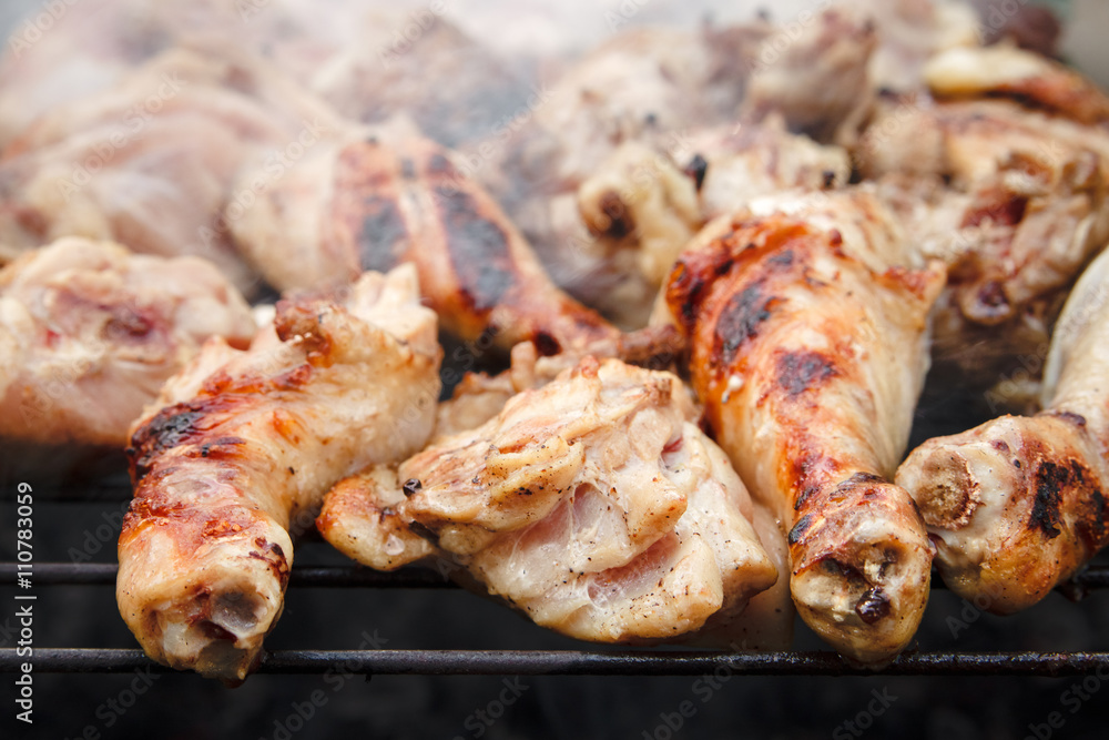 The is Grill Chiken Sticks on the Grid with Smoke,Fried Meet,Cooking Outside,Picnic with Barbecue,Selective Focus