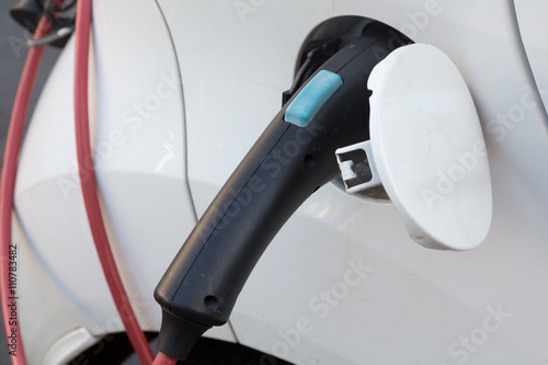 Charging an electric car with the power cable supply plugged