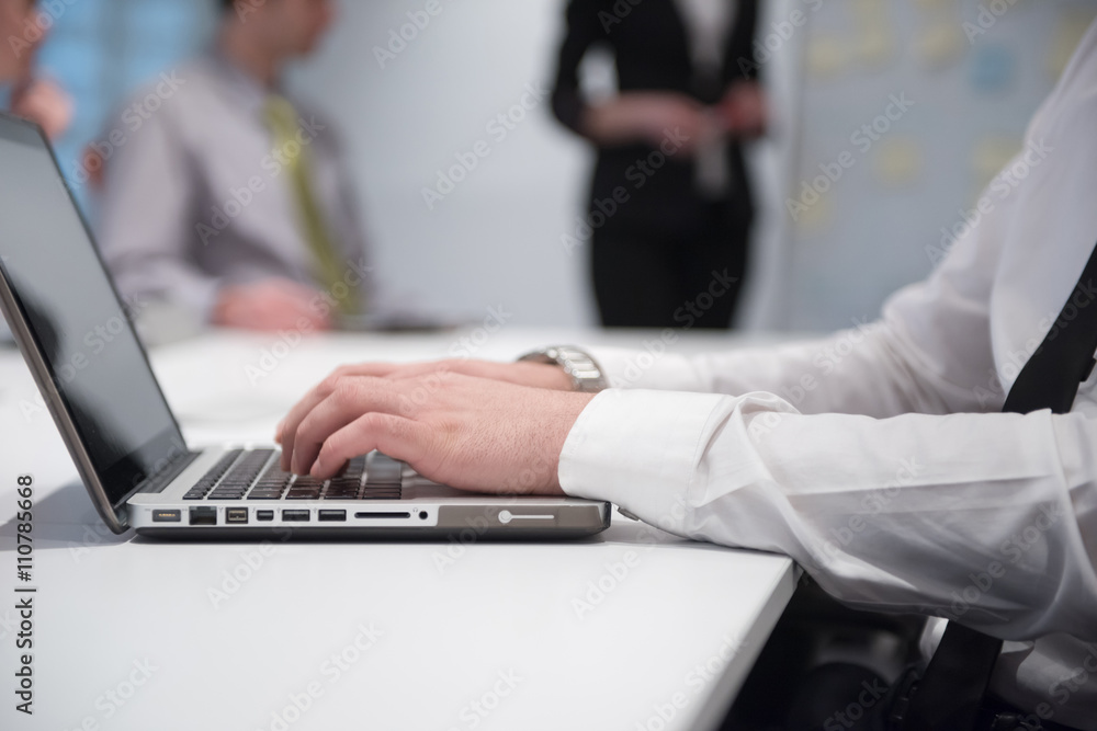 hands typing on laptop at meeting hands typing on laptop at meeting