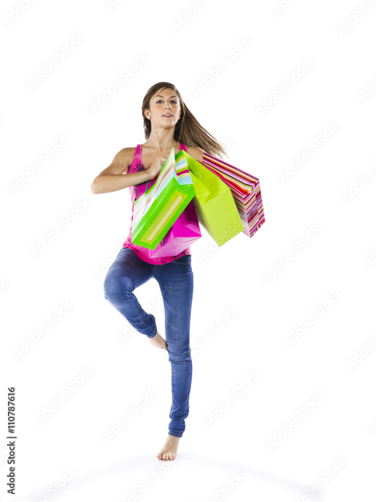 teenage girl with shopping bags standing on one leg. teenage girl with shopping bags standing on one leg.