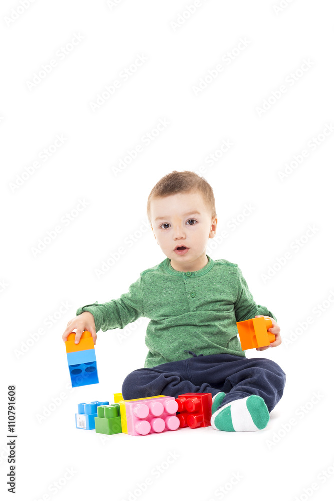 Cute little boy playing with colorful blocks Cute little boy playing with colorful blocks