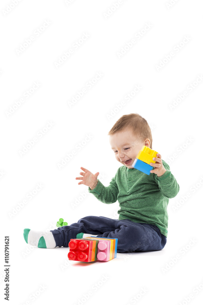 Laughing little boy playing with colorful blocks Laughing little boy playing with colorful blocks