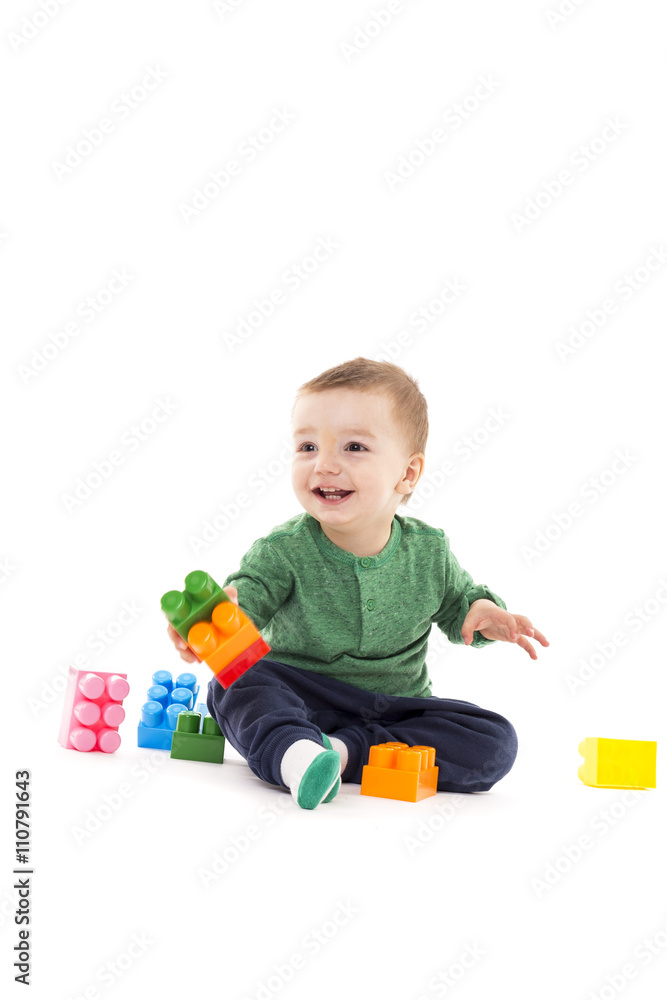 Laughing little boy playing with colorful blocks Laughing little boy playing with colorful blocks