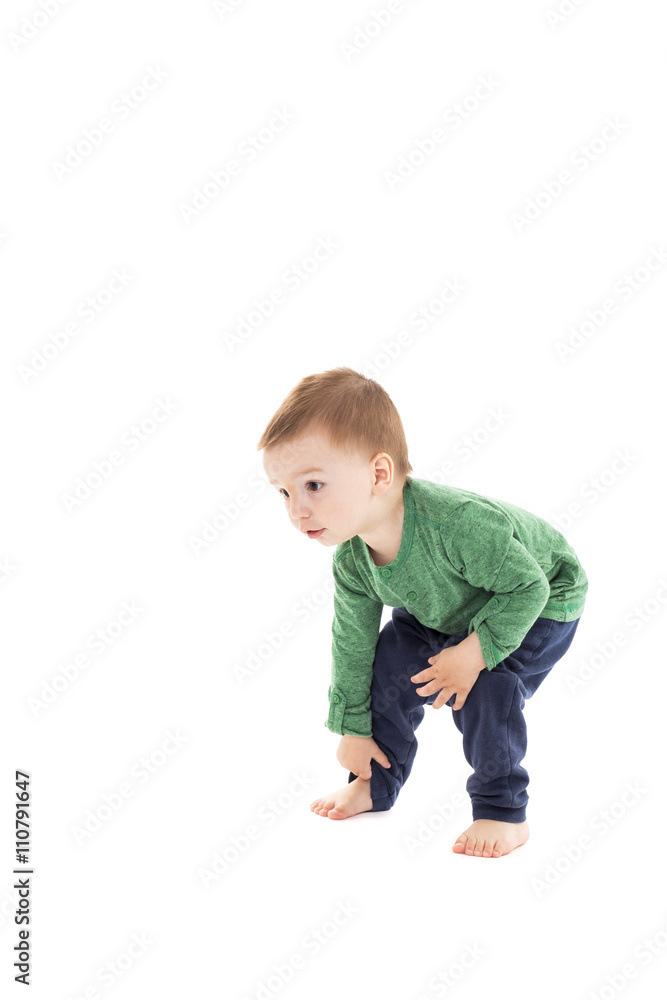 Adorable little boy trying to stand up