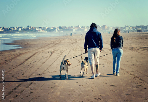 Photography Father and daughter  walking their dogs along the beach in Mar del Plata, Argent
