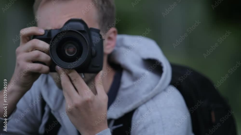 Young Man Taking Pictures At A Professional Digital SLR Camera Young Man Taking Pictures At A Professional Digital SLR Camera