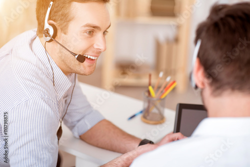 Pleasant man working with his colleague 