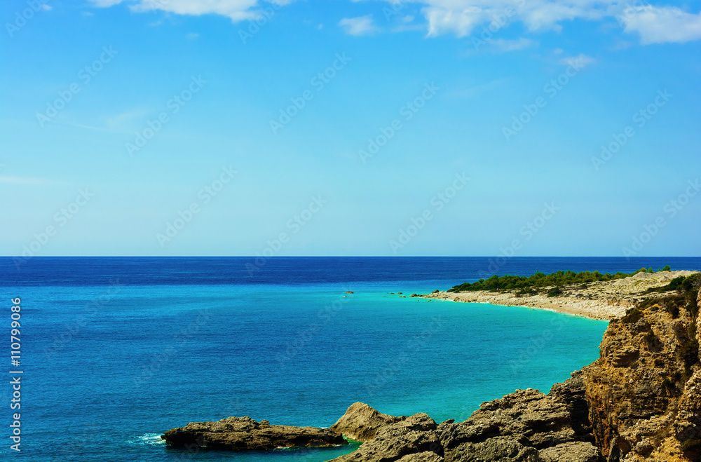 View of beautiful beach with rocky cliffs at mediterranean sea