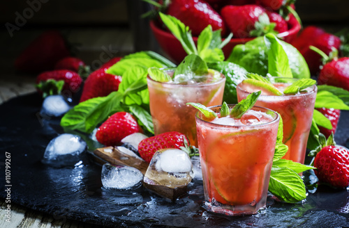 Alcoholic cocktail strawberry mojito with white rum, syrup, soda