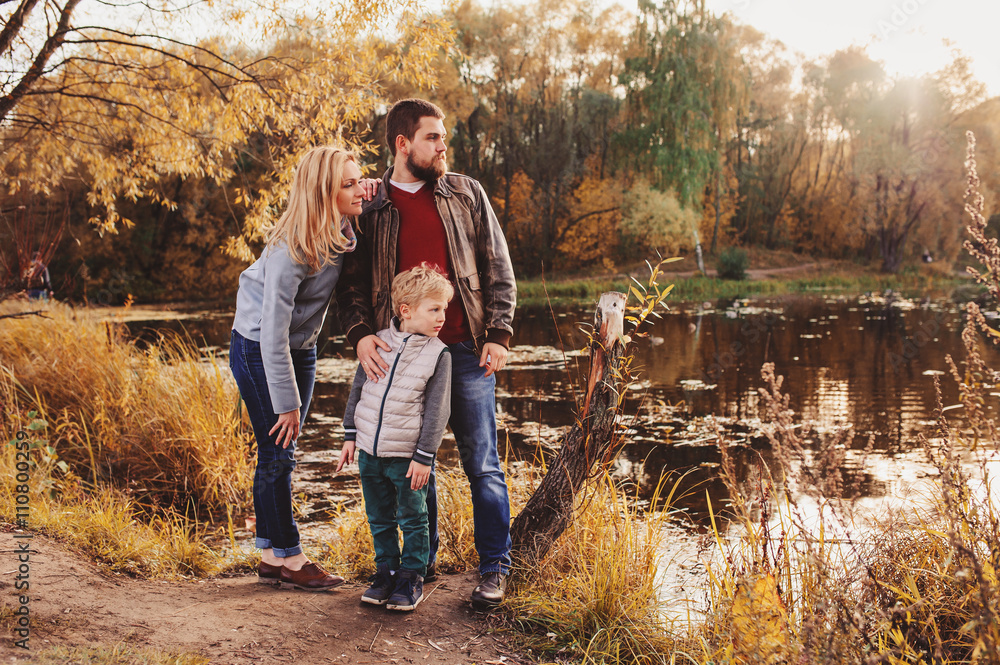 happy family spending time together outdoor. Lifestyle capture, rural cozy scene. Father, mother and son walking in forest happy family spending time together outdoor. Lifestyle capture, rural cozy scene. Father, mother and son walking in forest