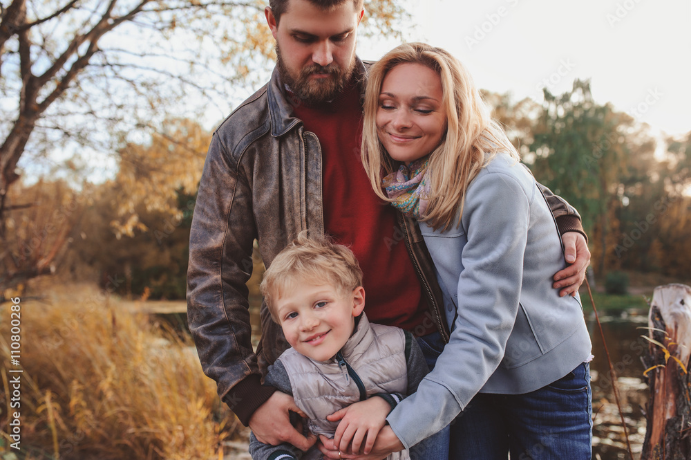happy family spending time together outdoor. Lifestyle capture, rural cozy scene. Father, mother and son walking in forest happy family spending time together outdoor. Lifestyle capture, rural cozy scene. Father, mother and son walking in forest