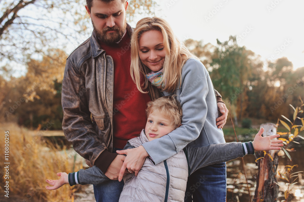 happy family spending time together outdoor. Lifestyle capture, rural cozy scene. Father, mother and son walking in forest happy family spending time together outdoor. Lifestyle capture, rural cozy scene. Father, mother and son walking in forest