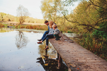 happy family spending time together outdoor. Lifestyle capture, rural cozy scene. Father, mother and son walking in forest