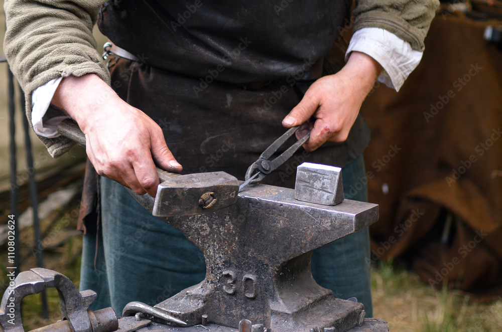 Blacksmith working on metal medieval Blacksmith working on metal medieval