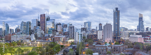  Toronto Financial District skyscrapers and the CN Tower apex at the background at twilight- panoramic