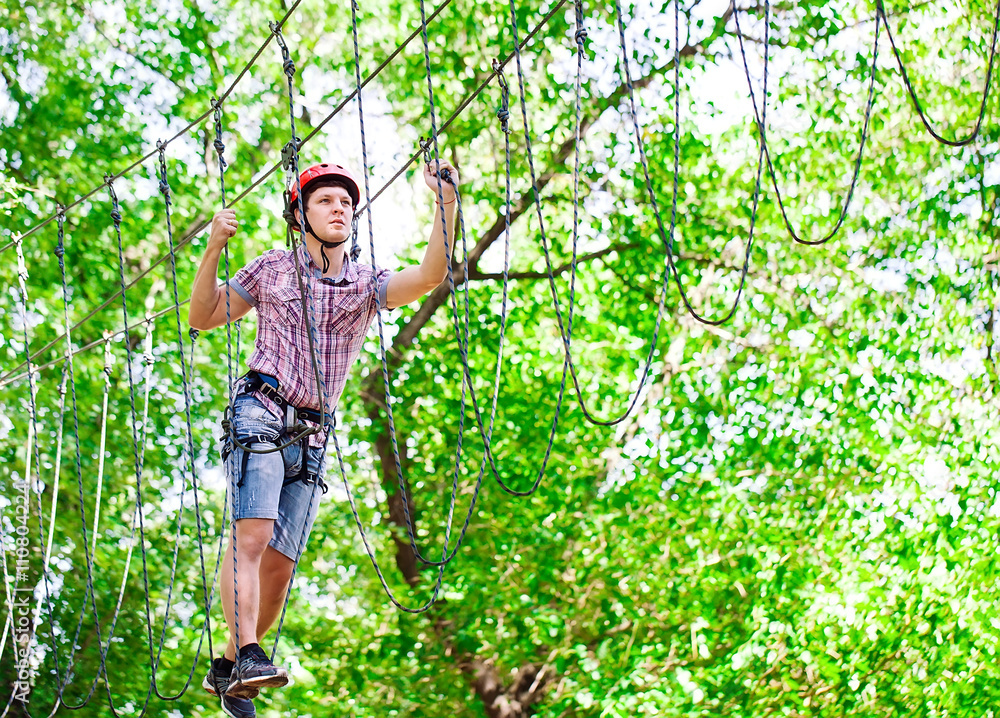 adventure climbing high wire park - people on course in mountain adventure climbing high wire park - people on course in mountain
