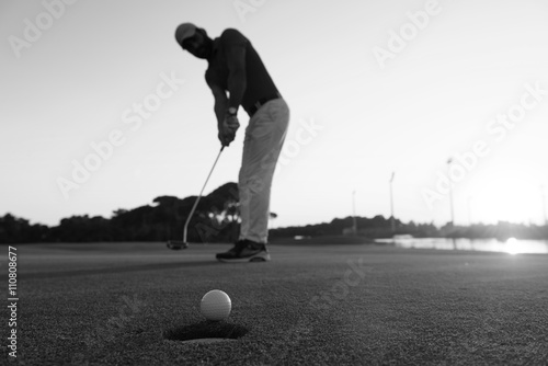 golfer hitting shot at golf course