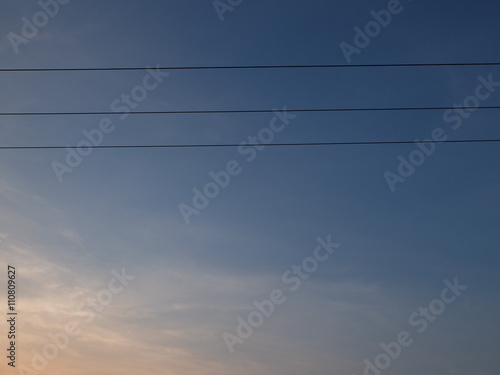 Triple power cables and sunset, blue sky