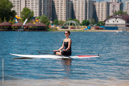 SUP athletic girl yoga meditation