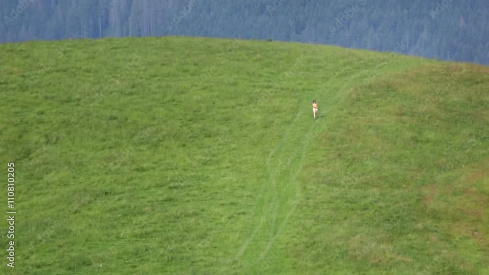 Female make selfie far on mountain meadow. Small people. Female make selfie far on mountain meadow. Small people.