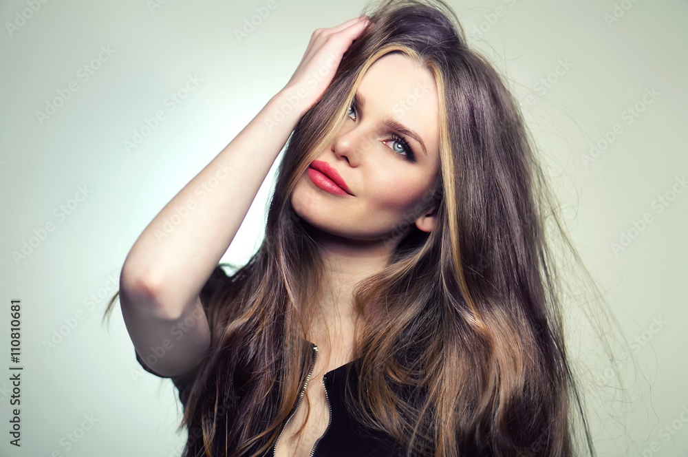 Beautiful young and emotional caucasian woman model with great hair and makeup, red lips and deep blue eyes - posing at studio in the softbox and light flashes. Beautiful young and emotional caucasian woman model with great hair and makeup, red lips and deep blue eyes - posing at studio in the softbox and light flashes.