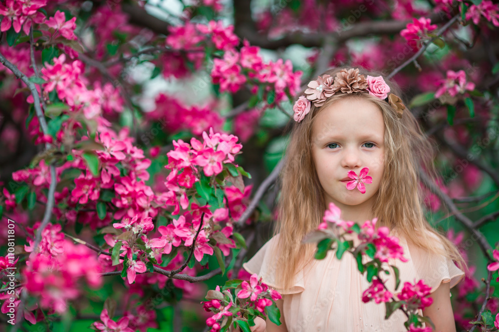 Portrait of little girl in beautiful blooming apple garden outdoors Portrait of little girl in beautiful blooming apple garden outdoors