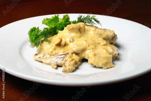 Veal with cheese sauce on plete