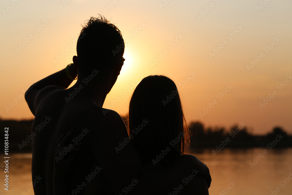 young couple sunset silhouette