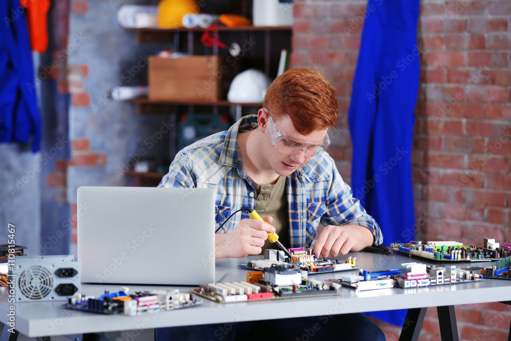 Young man working in repair center Young man working in repair center