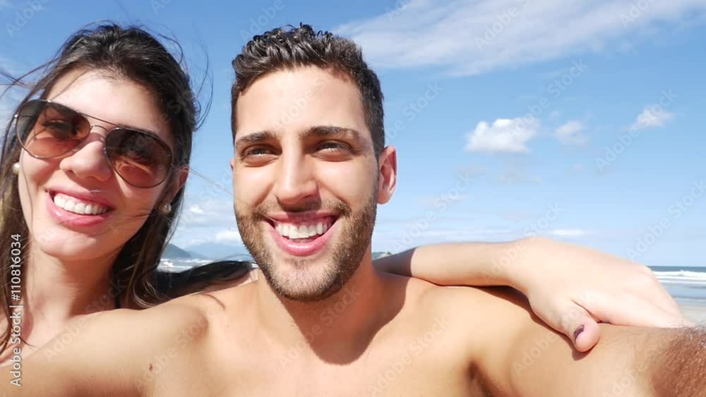 Couple having fun and taking selfies on the beach, Brazil in Slow Motion Couple having fun and taking selfies on the beach, Brazil in Slow Motion