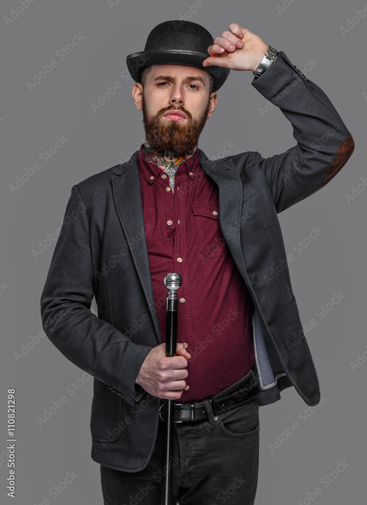 Tattooed bearded man in a suit holding cane Tattooed bearded man in a suit holding cane