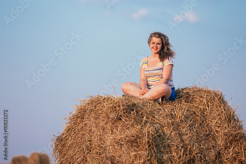 Beautiful Plus Size Young Woman In Shirt Sit Near Hay Bales In S
