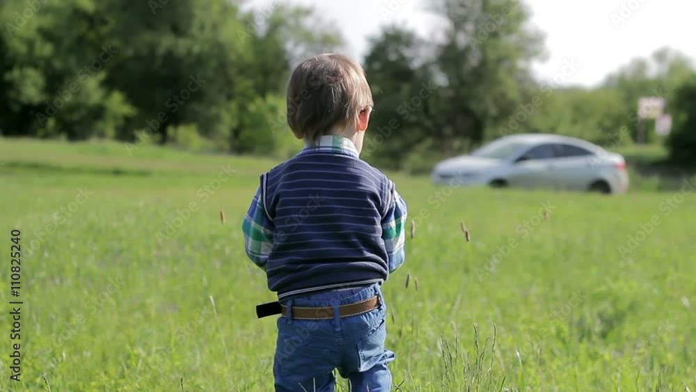 The little boy walks on nature with telephone The little boy walks on nature with telephone