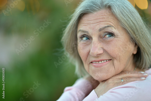 elderly woman in tropical garden
