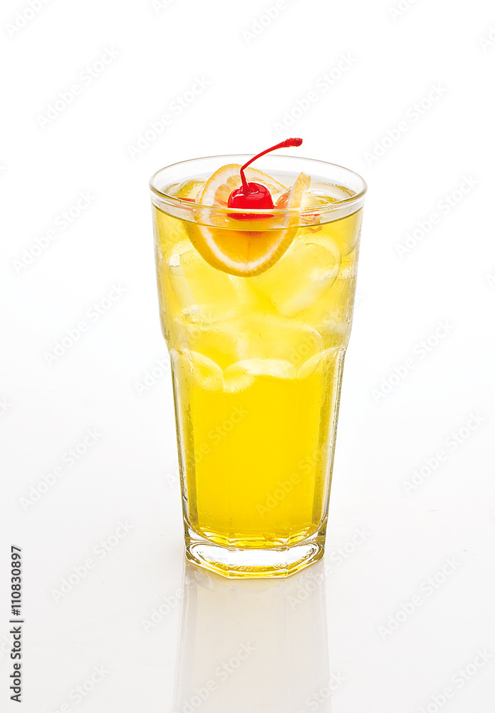 yellow cocktail decorated with cherry and lemon isolated on white.