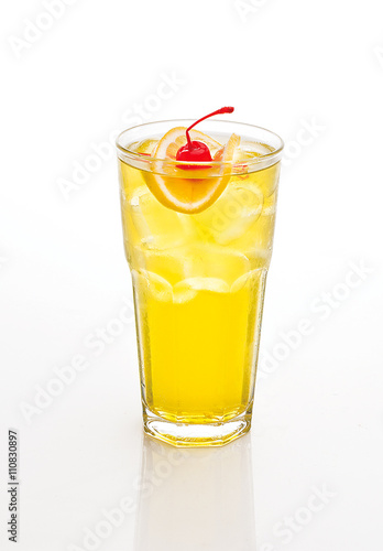 yellow cocktail decorated with cherry and lemon isolated on white.